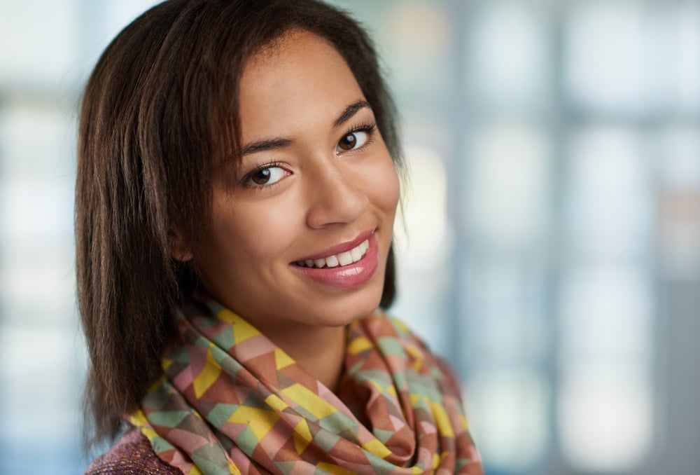 Horizontal headshot of an attractive african american business woman shot with shallow depth field.